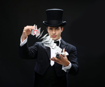 magician-showing-trick-with-playing-cards